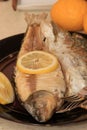 Whole on salt cooked fish with skin removed on one side .Whole fish cooked in a salt