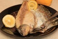 Whole on salt cooked fish with skin removed on one side .Whole fish cooked in a salt