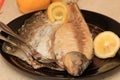 Whole on salt cooked fish with skin removed on one side .Whole fish cooked in a salt