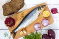 Whole salted herring with boiled beet, red onion, garlic, lemon, dill, rye bread. Royalty Free Stock Photo