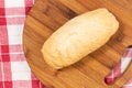 Whole sandwich bread on the kitchen cutting wooden board