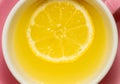 A whole slice of lemon floating in tea or lemonade in a pink mug Royalty Free Stock Photo