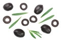 Whole and sliced black olives with rosemary leaves isolated on white background. Top view. Flat lay pattern Royalty Free Stock Photo