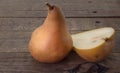 Whole and sliced Bosc pear on wood Royalty Free Stock Photo