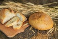 Whole and sliced bread with ears and wheat grain Royalty Free Stock Photo