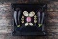 Whole and sliced eggplants on baking tray