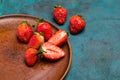 Whole and sliced fresh red strawberries in ceramic plate Royalty Free Stock Photo