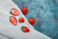 Whole and sliced fresh red strawberries on linen napkin with copy space Royalty Free Stock Photo