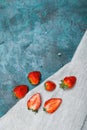 Whole and sliced fresh red strawberries on linen napkin with copy space Royalty Free Stock Photo