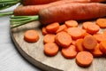 Whole and sliced fresh ripe juicy carrots on white wooden table, closeup Royalty Free Stock Photo