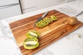 Whole and sliced kiwi fruit on wooden cutting board. Royalty Free Stock Photo