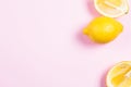 Whole and sliced lemon on pink background Royalty Free Stock Photo