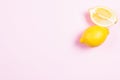 Whole and sliced lemon on pink background Royalty Free Stock Photo