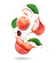 Whole and sliced peaches with juice splashes in the air isolated on a white background Royalty Free Stock Photo