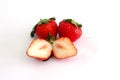 Whole and sliced piece strawberry fruit.