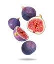 Whole and sliced ripe figs close up in the air isolated on a white background Royalty Free Stock Photo