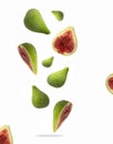 Whole and sliced ripe green figs in the air on a white background Royalty Free Stock Photo