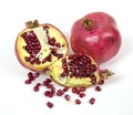 Whole and slices of red ripe pomegranate with seeds isolated on a white background. Raw organic fruits vegetables. Royalty Free Stock Photo