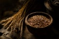 Whole spelt grains, uncooked, in a bowl, accompanied by spelt ears. Royalty Free Stock Photo