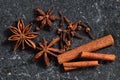 Whole spice - cinnamon, clove and star anise on a dark marble table. Spices of golden brown color, closeup, wiev from above