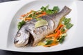 Whole steamed dorado fish