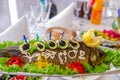 Whole stuffed fish on an oblong dish, decorated with lemon, vegetables and olives. A traditional Jewish dish or banquet dish.