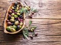 Whole table olives in the wooden bowl. Royalty Free Stock Photo