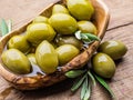 Whole table olives in the wooden bowl on the table Royalty Free Stock Photo