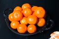 Whole tangerine in a bowl top view