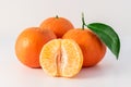 Whole tangerines or mandarines orange fruits and peeled segments Royalty Free Stock Photo