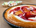 Whole tart decorated cream behind