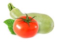 Whole tomato and light green zucchini with leaf isolated Royalty Free Stock Photo