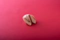 A whole traditional Chinese fortune cookie on a red background. Royalty Free Stock Photo