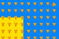 Whole triangular nachos slices on colorful blue and yellow background Royalty Free Stock Photo