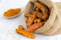 Whole Turmeric Rhizomes in a Sack on White Background Royalty Free Stock Photo