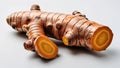 Whole turmeric root with orange cut edge and knobby skin centered on white background Royalty Free Stock Photo