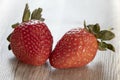 Whole two strawberries with leaf  on wooden background. Fresh ripe strawberries isolated. Healthy diet nutrition concept. Royalty Free Stock Photo