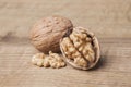 Whole unpeeled and broken walnuts on a white background. Royalty Free Stock Photo