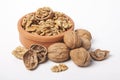 Whole unpeeled and broken walnuts on a white background. Royalty Free Stock Photo