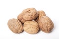 Whole unpeeled and broken walnuts on a white background. Royalty Free Stock Photo