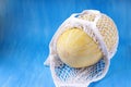 Whole Uzbek melon in the mesh bag