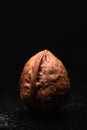 Whole walnut nut on dark wooden table