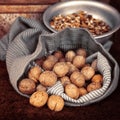 Whole walnuts in bag on the background walnut kernels in the bowl Royalty Free Stock Photo