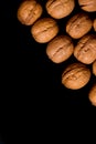 Whole walnuts and cleared on old black metal background, top view. Space for text Royalty Free Stock Photo