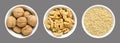 Whole, walnuts, kernel halves and ground walnuts in white bowls on gray background