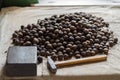 Whole walnuts on old table with anvil and hammer