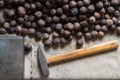 Whole walnuts on old table with hammer from above