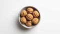Whole Walnuts in Rustic Ceramic Bowl on White Background, Top View Royalty Free Stock Photo