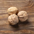 Whole walnuts on rustic old wooden table Royalty Free Stock Photo