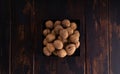 Whole walnuts on a square plate on wooden table, top view. Healthy nuts and seeds composition. Royalty Free Stock Photo